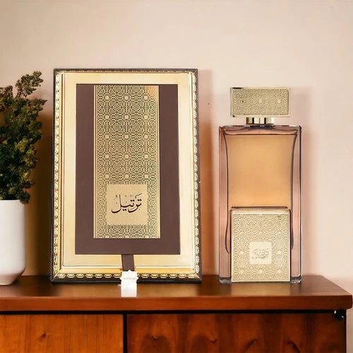 Arabian Perfume bottle and decorative box on a wooden surface with a plant in the background